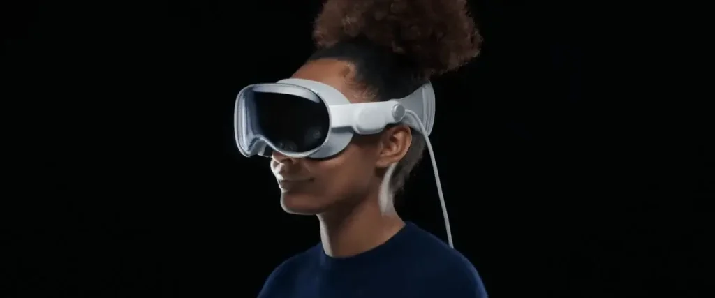 Person wearing a white apple vision pro, profile view against a black background.